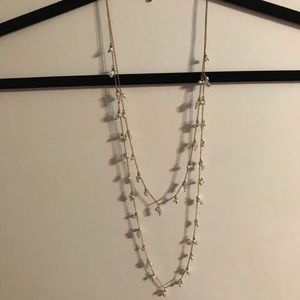 Gold necklace with white bead detail